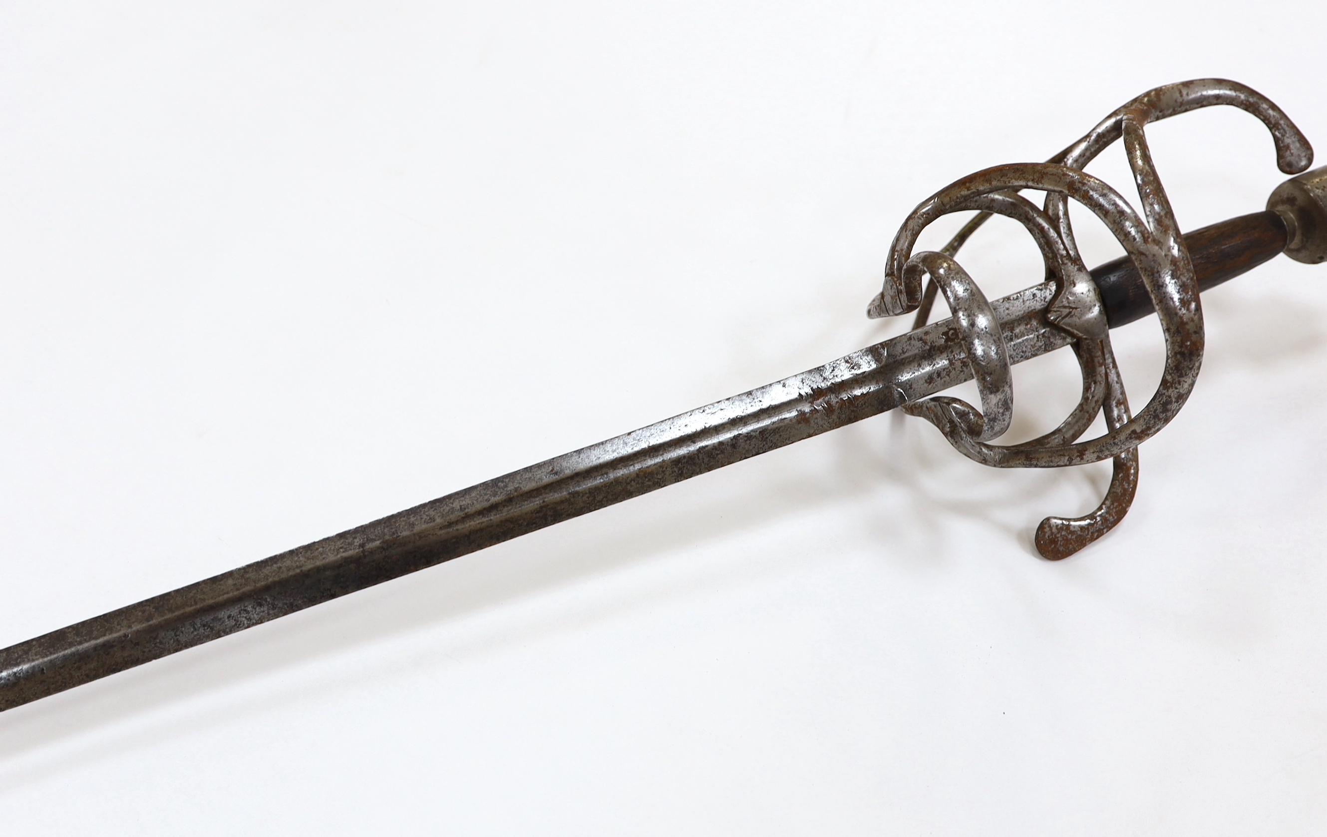 A swept hilt rapier, c.1620, blade fullered at the forte, iron guard of conventional form with later pommel and wooden grip, blade 113cm